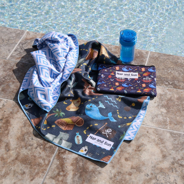 Blue, pirate, whale pattern children beach towel by the poolside with a wetbag