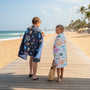 Kids walking on beach covered in cute towels