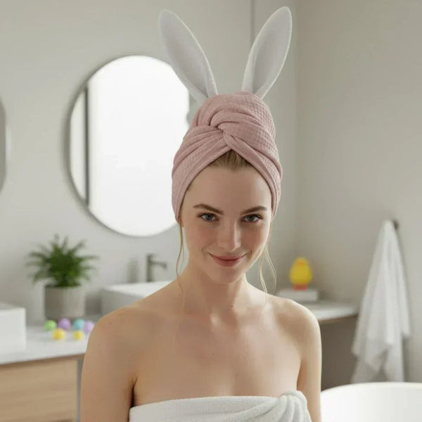 Woman with pink hair wrap and bunny ears in a bathroom