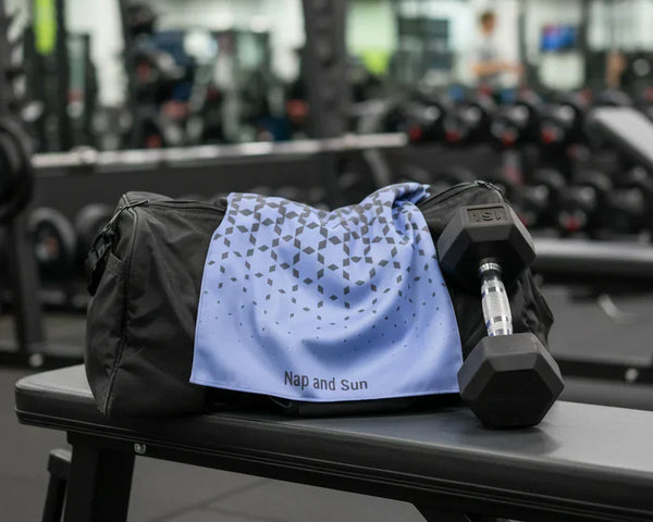 Blue sport towel on a gym bag in a gym.