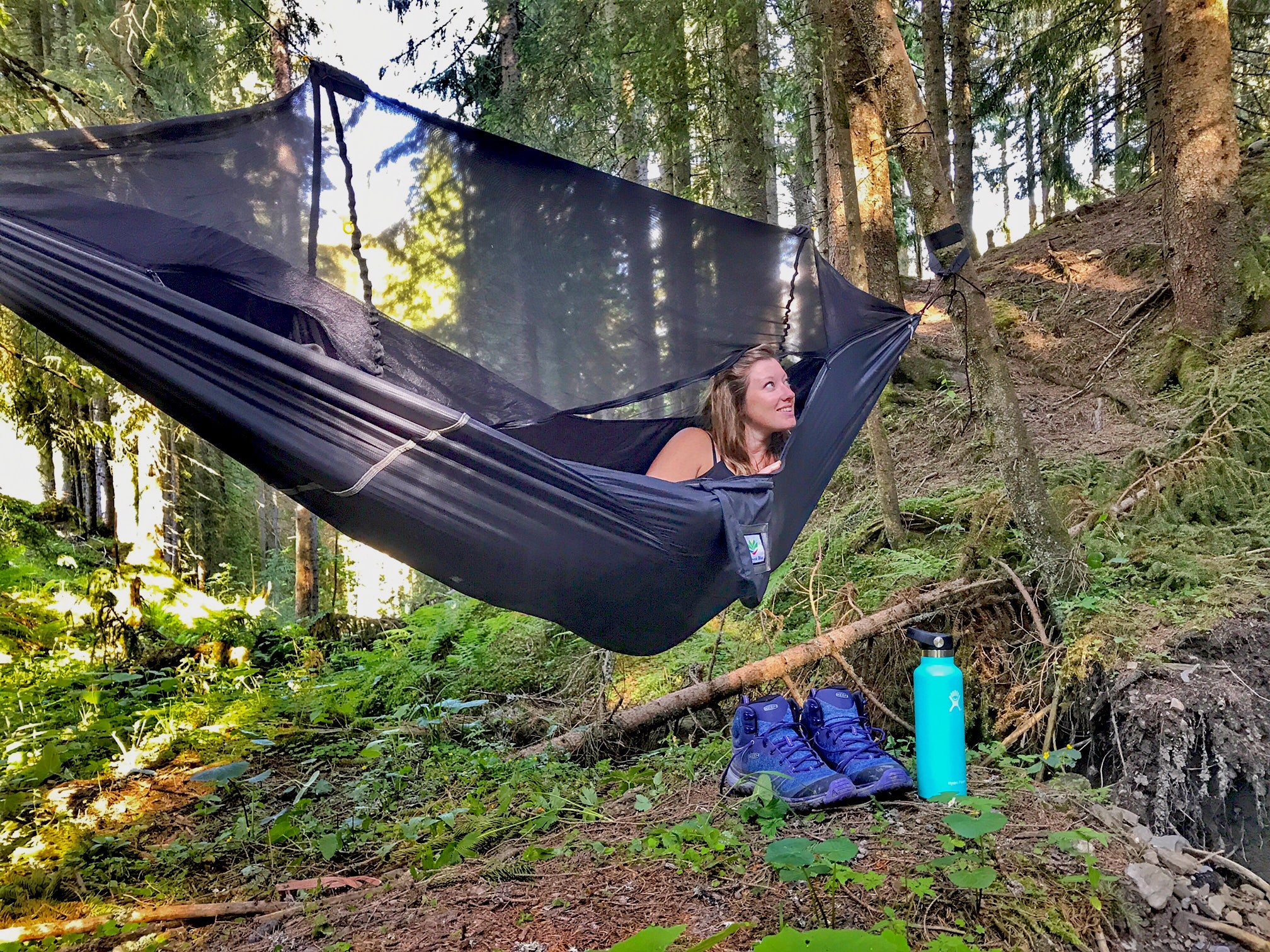 Woman relaxing in a hammock in a forest 