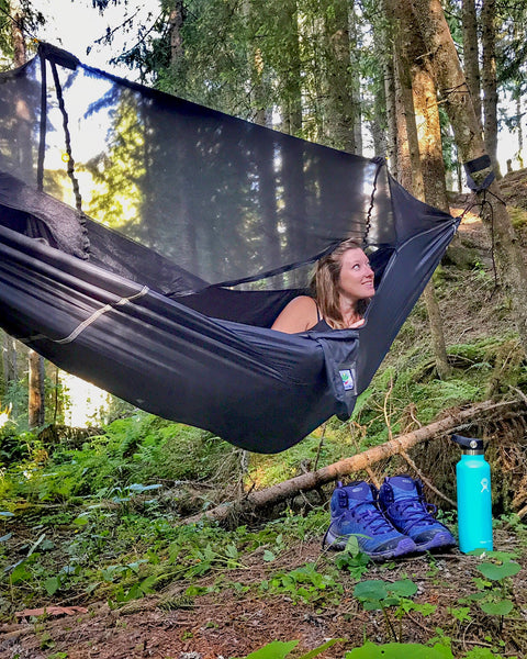 Woman relaxing in a hammock in a forest 