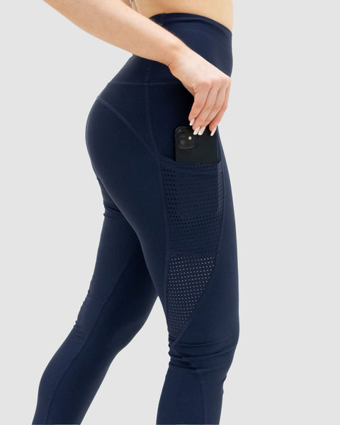 Navy blue leggings with pocket on a light gray background