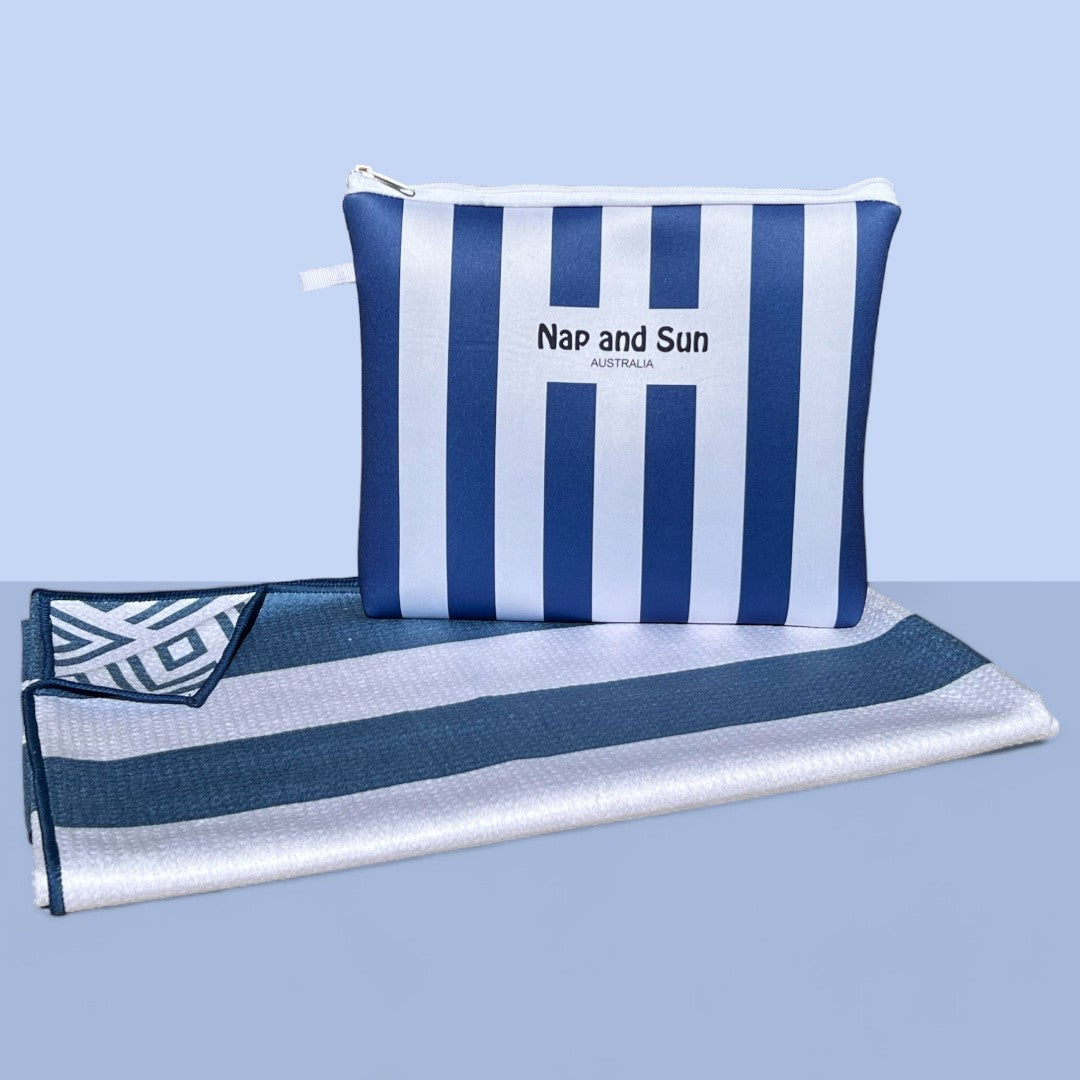 Nap and Sun Stripe Love sand-free beach towel featuring a double sided design. Front: bold, alternating navy blue and white horizontal stripes. Back: White background blue geometric lines. free matching wetbag included. 