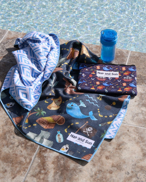 Blue, pirate, whale pattern children beach towel by the poolside with a wetbag