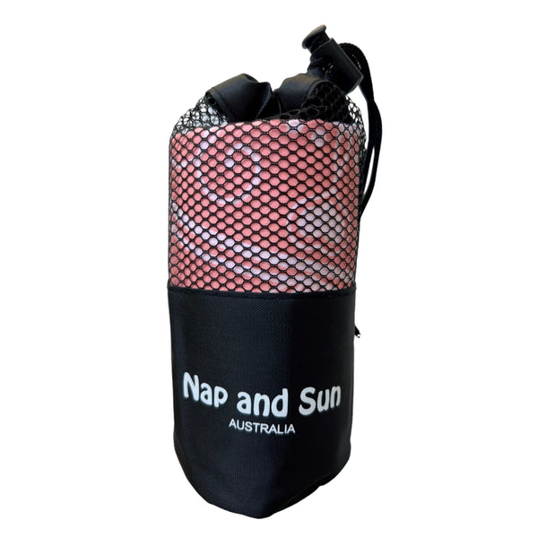Pink gym towel called 'Balance' stored in a black mesh bag with the Nap and Sun Australia logo on the bag.