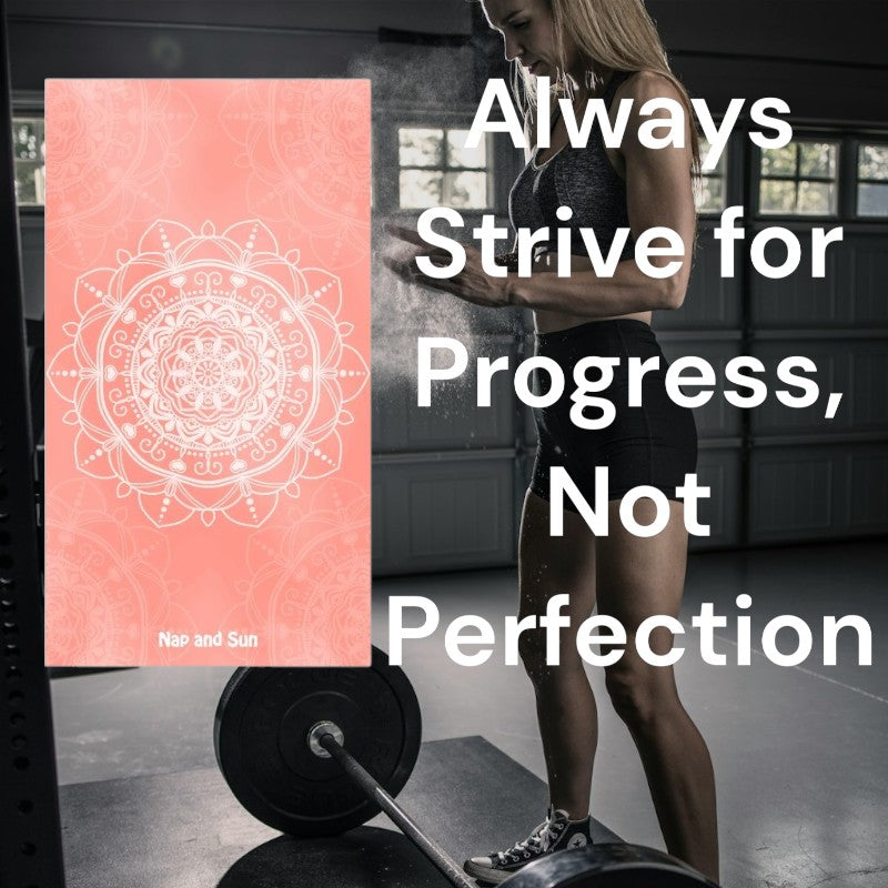 Lady in a gym standing above a heavy weight, applying white powder to her hands, with a pink mandala towel superimposed on the image. Text overlay: 'Always Strive for Progress, Not Perfection.