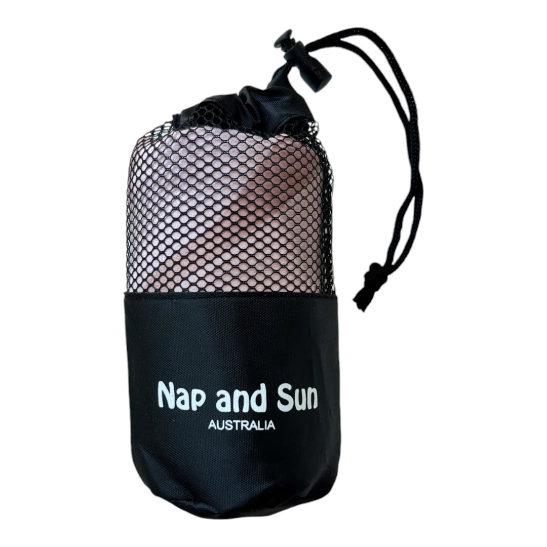 Nude colour gym towel with flower pattern called 'Energy' stored in a black mesh bag with the Nap and Sun Australia logo on the bag.