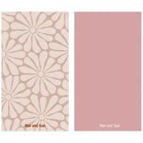 Nap and Sun Nude background towel with light nude hippy-style flower pattern, solid pink color on the back, eco-friendly, quick-dry, and compact design