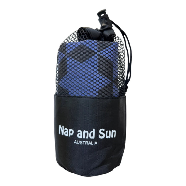 Indigo colour gym towel with black star pattern called Power stored in a black mesh bag with the Nap and Sun Australia logo on the bag.