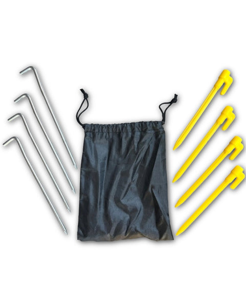 A black bag is placed beside four yellow plastic pegs and four steel pegs -for beachmats / picnic mats