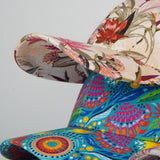 Colorful floral-patterned chair with a vibrant design on a plain background