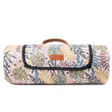 Floral-patterned picnic blanket with a brand label on a white background