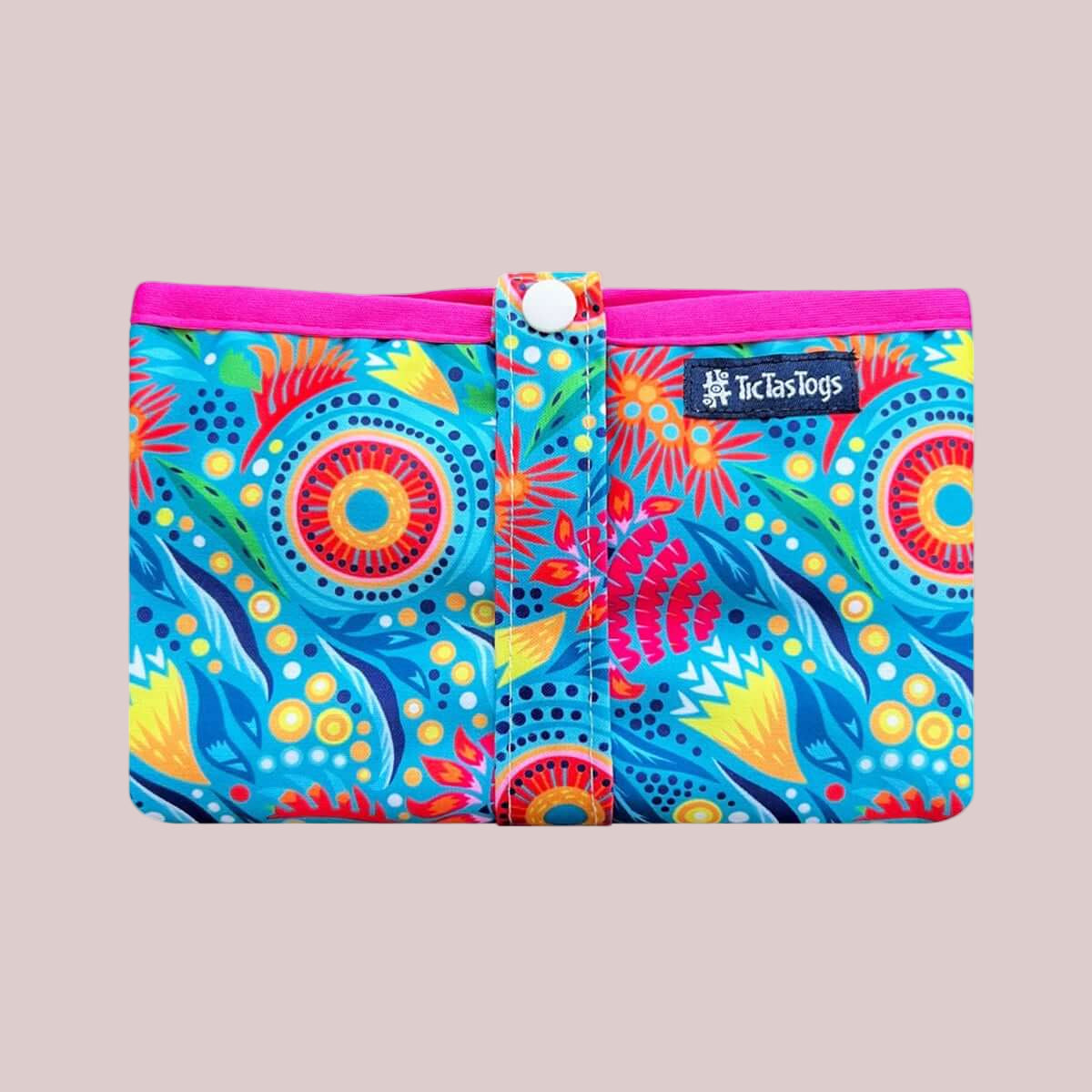 Colorful pouch with floral pattern and pink border on a beige background