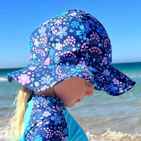 Child is wearing a blue floral sun hat