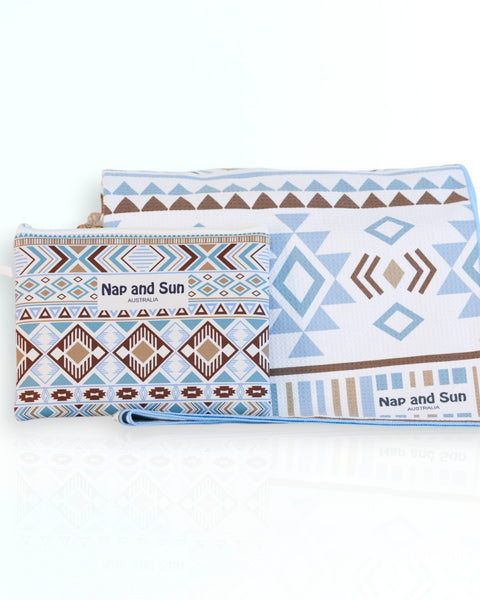 Nap and Sun Azure Tribe sand-free beach towel featuring a vibrant tribal pattern in shades of blue, white, and brown.  Free matching wetbag included. 