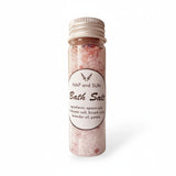 Bottle of bath salts with a label on a white background