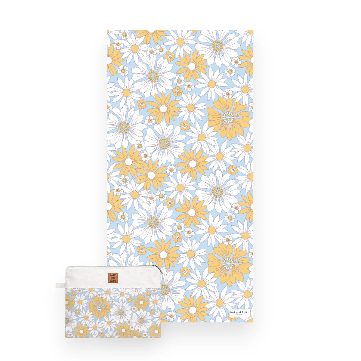 White and yellow daisy flower patterned beach towel on a light blue bachkground with a matching bag.