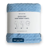 Blue hair wrap towel wrapped in a paper sleeve