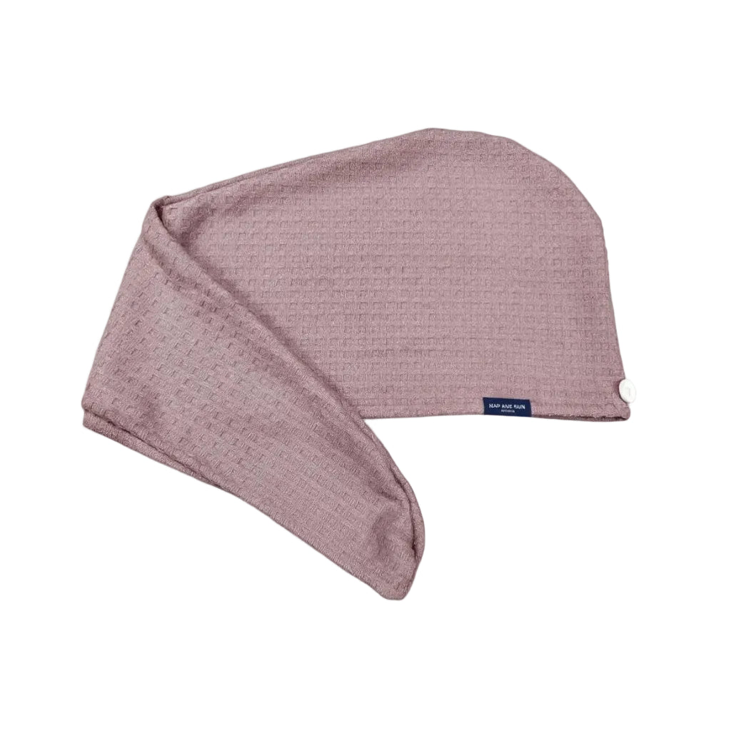 A dusty rose waffle-knit hair towel with a small navy blue brand tag reading 'Nap and Sun', shown on a clean white background.