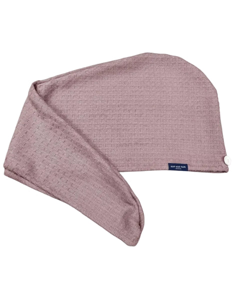 A dusty rose waffle-knit hair towel with a small navy blue brand tag reading 'Nap and Sun', shown on a clean white background.
