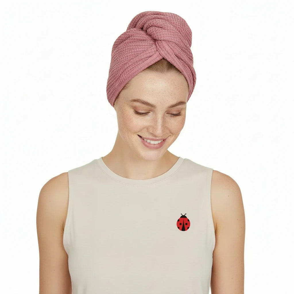 Woman wearing a pink head wrap on a white background