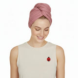 Woman wearing a pink head wrap on a white background