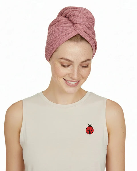 Woman wearing a pink head wrap on a white background