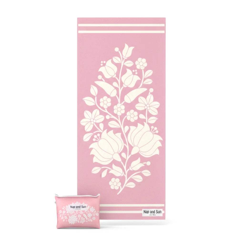 PInk floral patterned beach towel with pouch on a white background