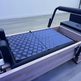 Blue patterned towel on a reformer in a pilates studio