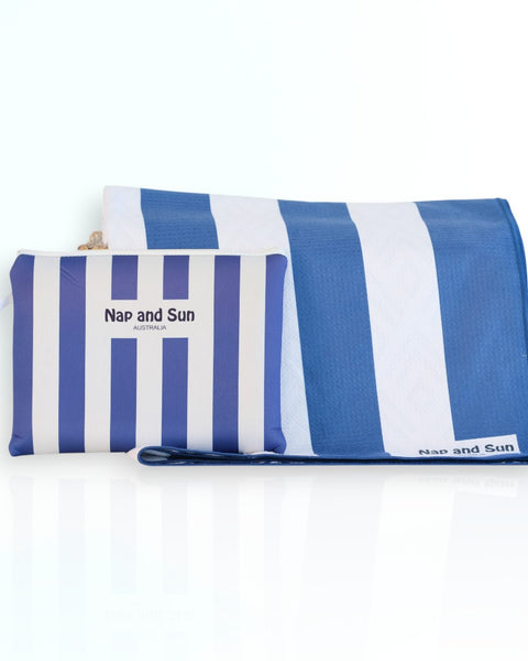 Nap and Sun Stripe Love sand-free beach towel featuring a bold, alternating navy blue and white horizontal stripes. Free matching wetbag included.