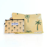 Napandsun Sunset Palms sand free beach towel featuring medium size palm trees on a yellow/goldish background. Free wetbag included. 