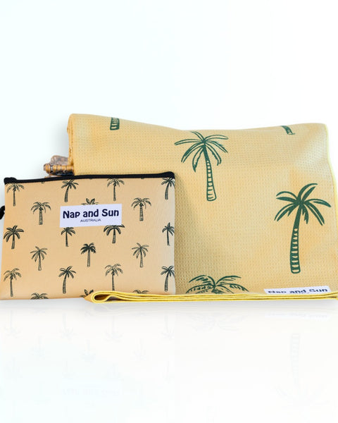 Napandsun Sunset Palms sand free beach towel featuring medium size palm trees on a yellow/goldish background. Free wetbag included. 