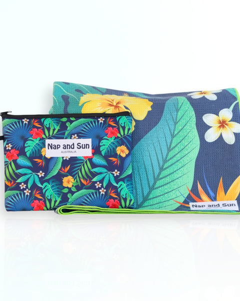 Napandsun Tropical Bliss sand-free beach towel featuring vivid green tropical leaves with yellow and red hibiscus and white frangipani flowers.  Free matching wet bag is included. 